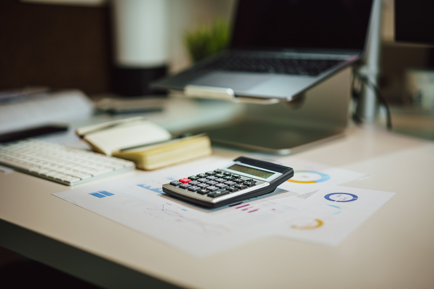 About Calculator on financial documents at an office desk.